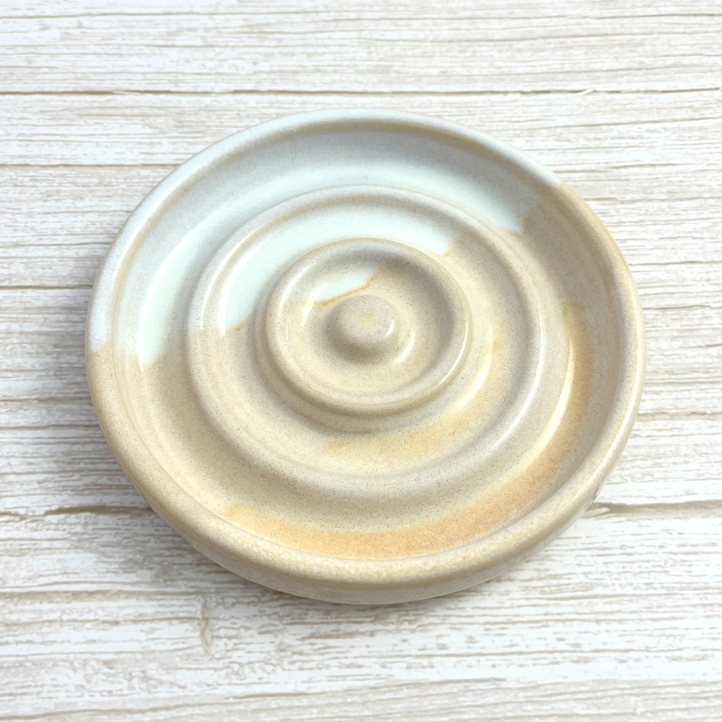 Hand-thrown heart shaped trinket dish. Crafted from premium white stoneware clay and finished with a beautiful blend of beige and white glazes.