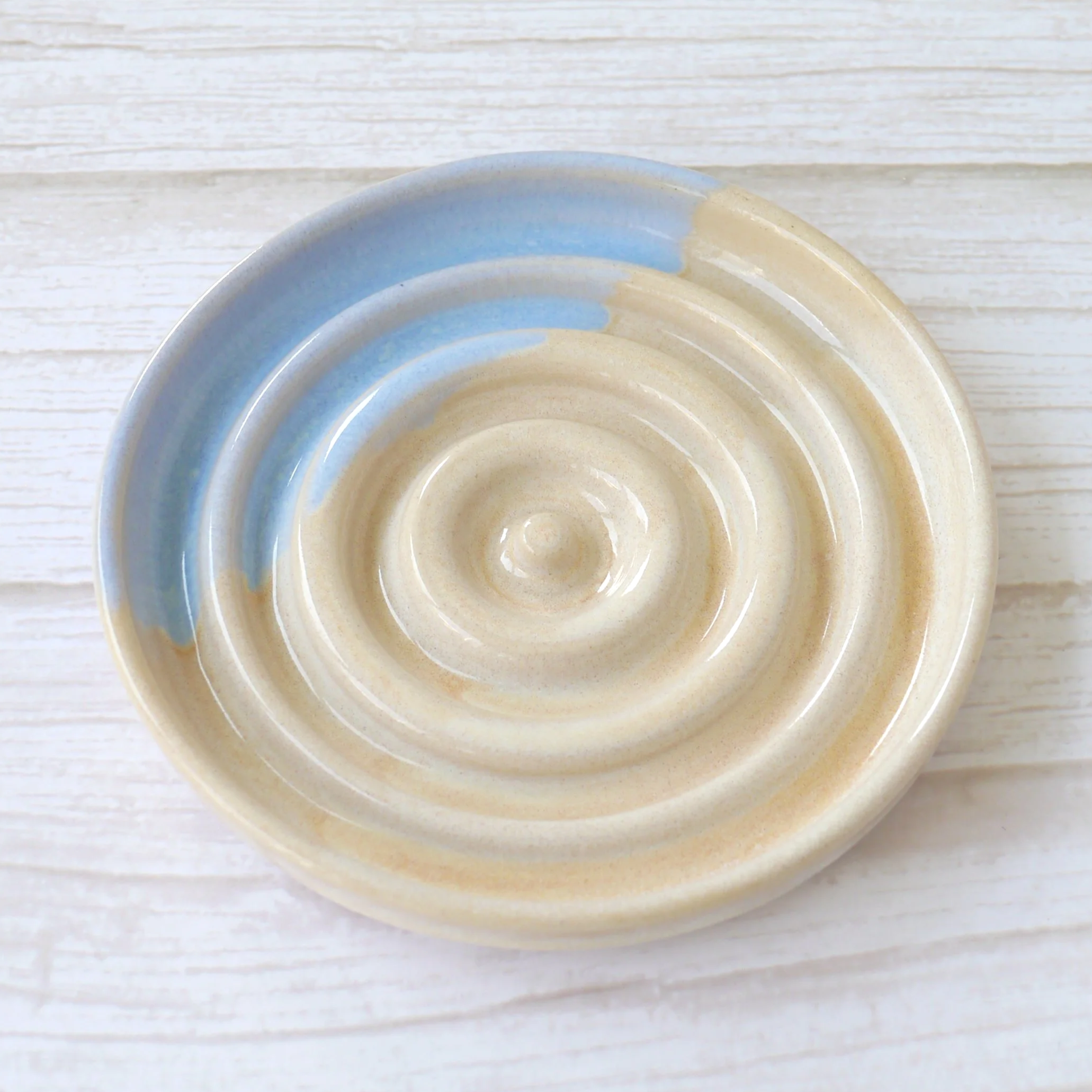 Hand-thrown heart shaped trinket dish. Crafted from premium white stoneware clay and finished with a beautiful blend of beige and blue glazes.