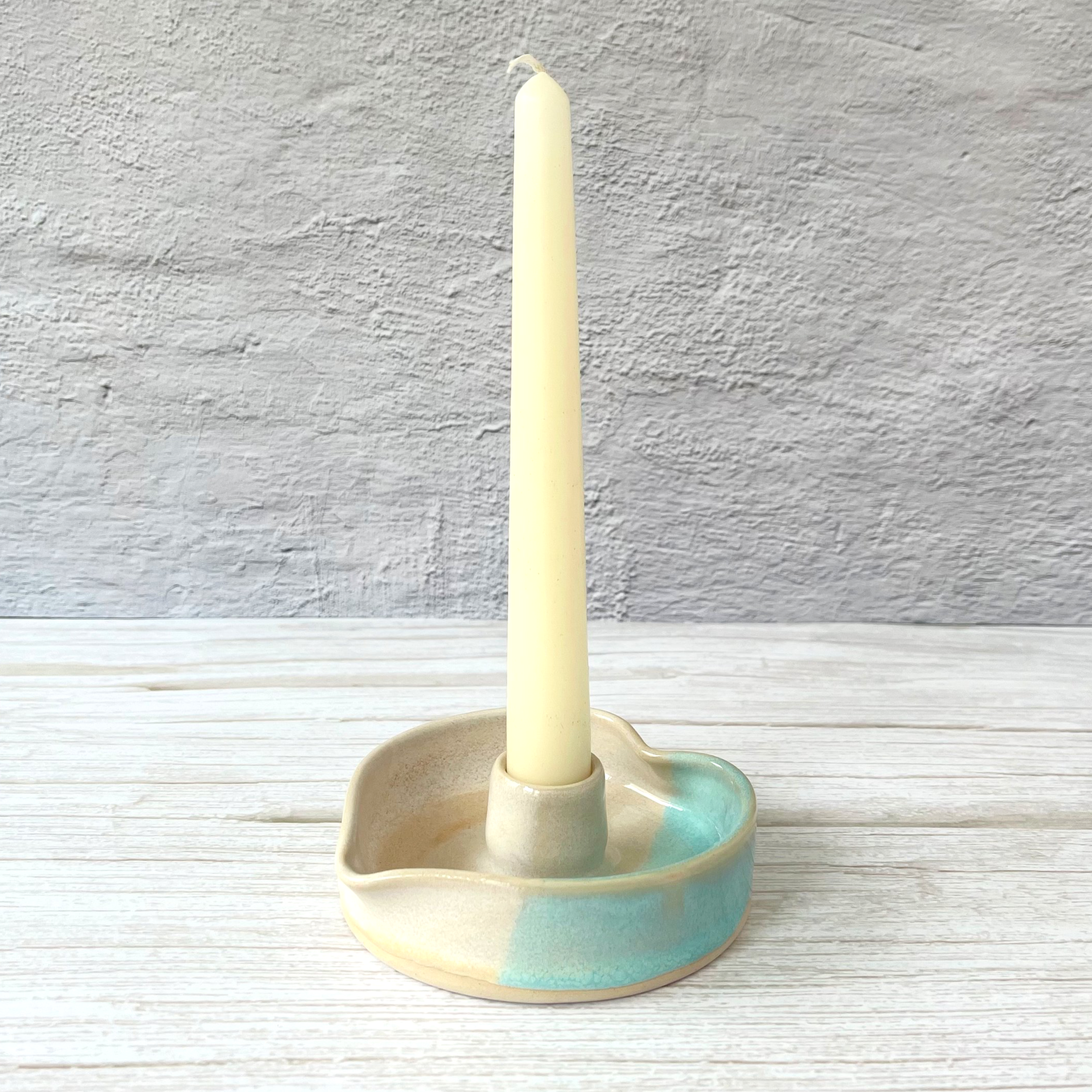 Handmade ceramic candlestick holder in a turquoise and cream glaze. For standard dinner candles