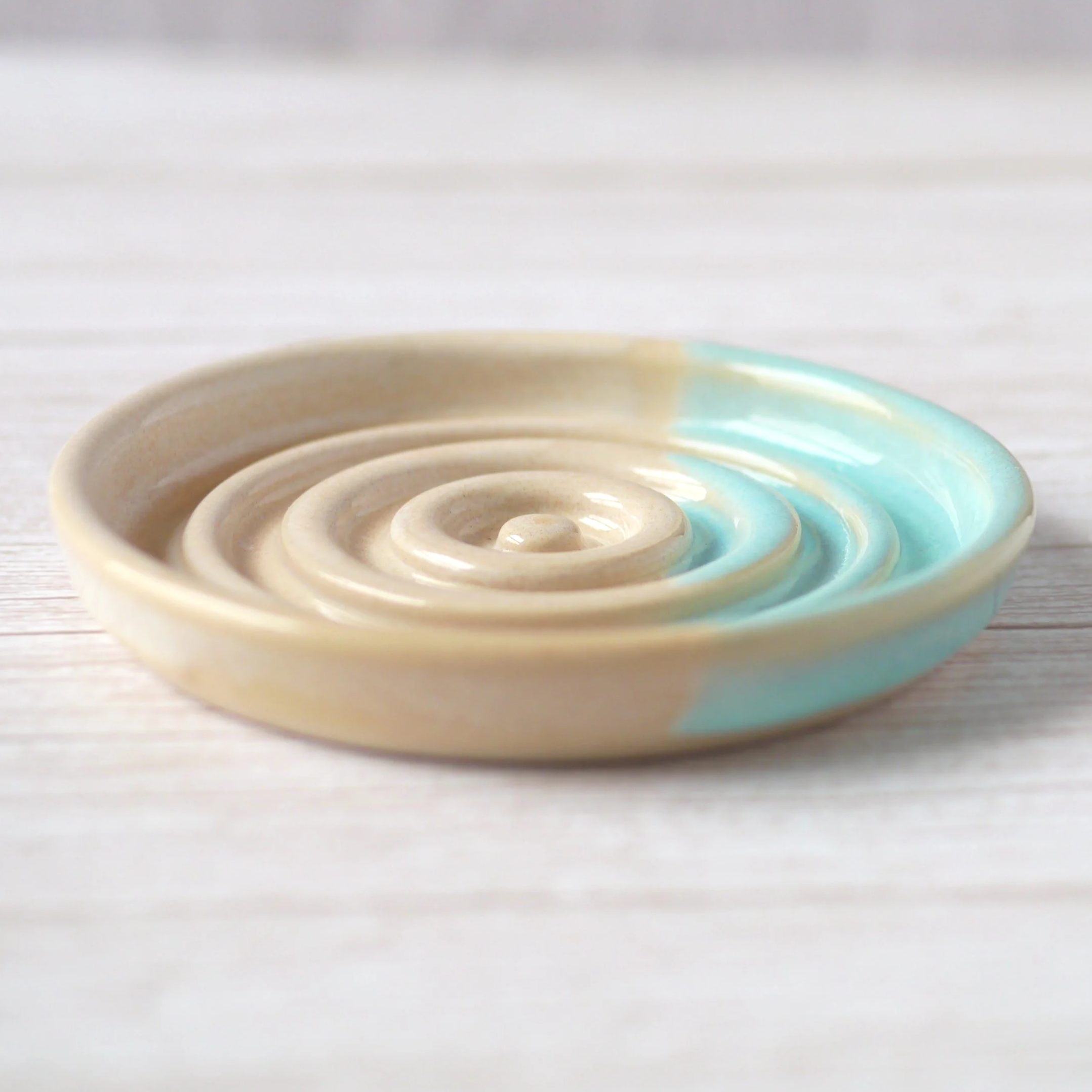 Hand-thrown heart shaped trinket dish. Crafted from premium white stoneware clay and finished with a beautiful blend of beige and turquoise glazes.