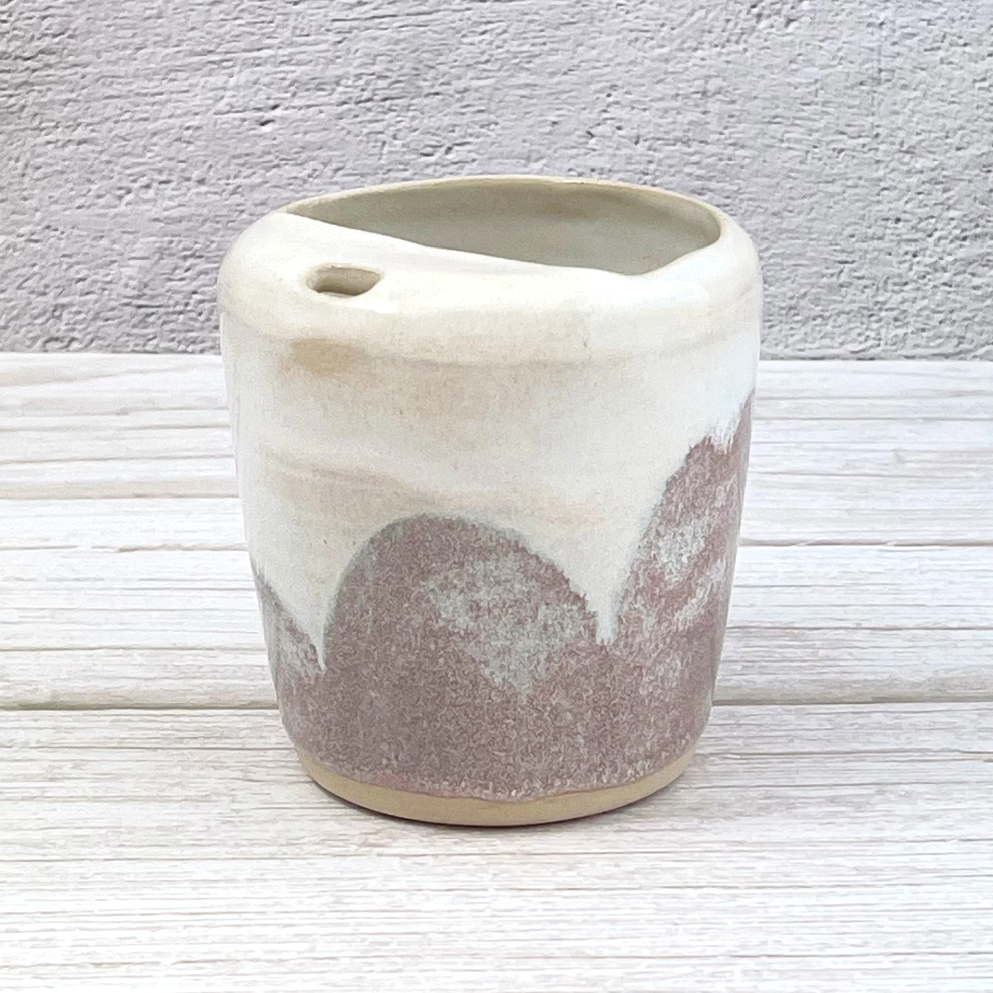 ceramic travel tumbler features a creamy white base layered with dusty lilac tones and delicate sage green speckles, forming organic, landscape-like patterns with a calm, natural texture