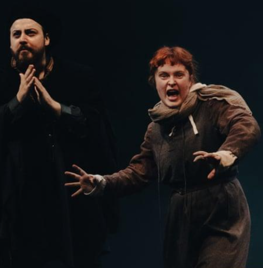 Image show two performers on stage. Alicia Meehan was the fight director and the movement director.