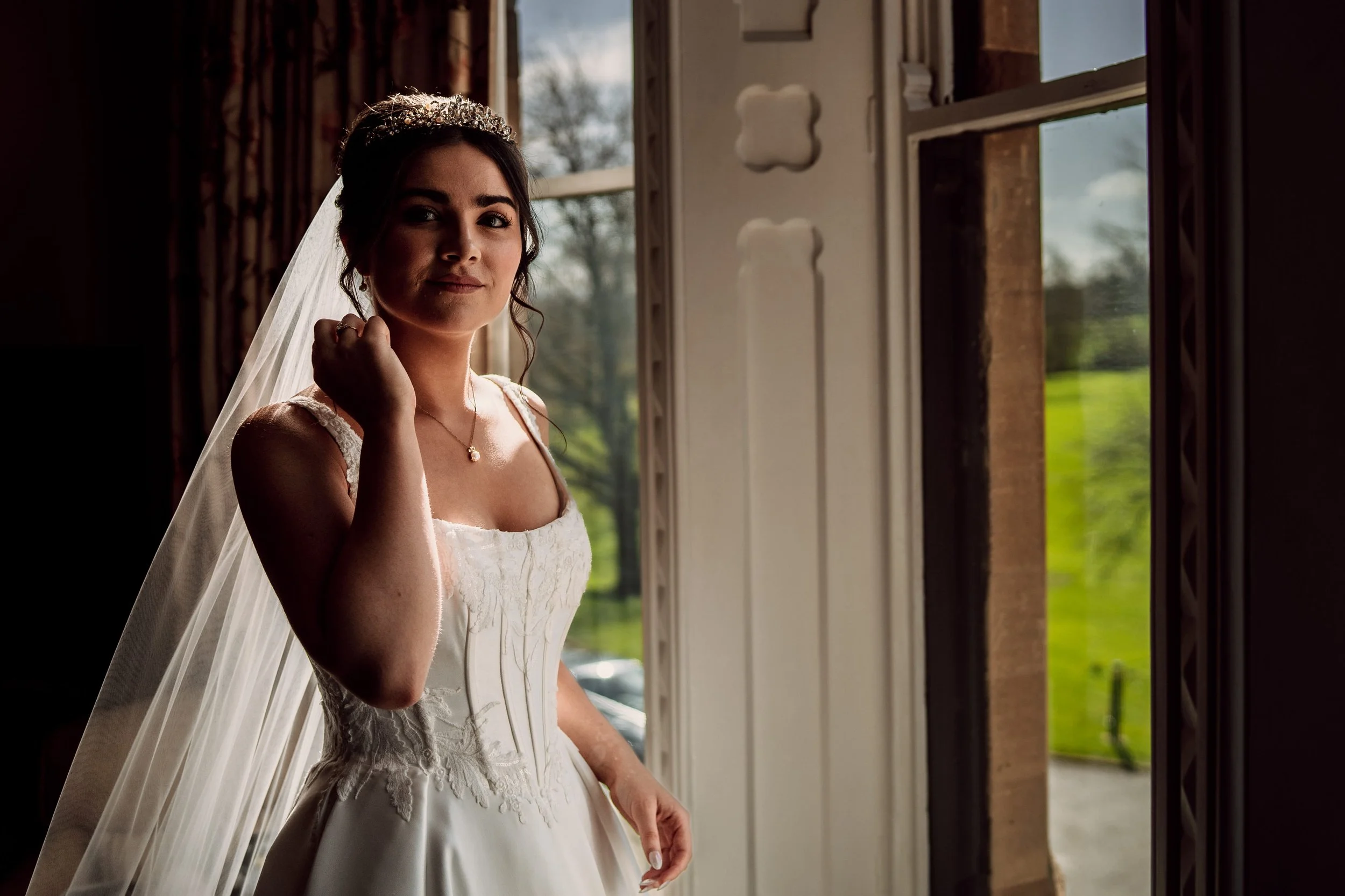 Bride portrait in the window at Ettington park