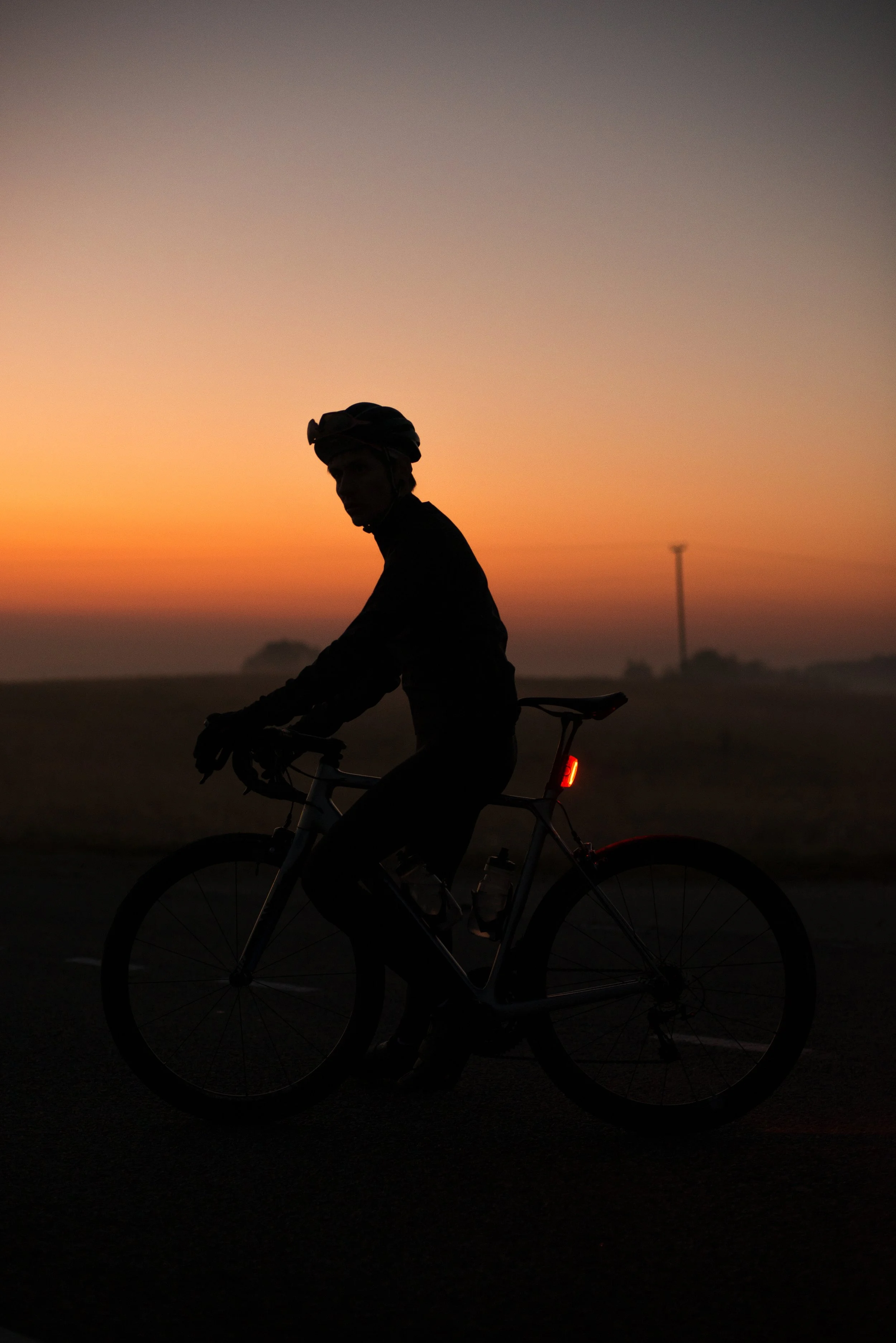 Radfahrer bei dunklem Licht am frühen Morgen