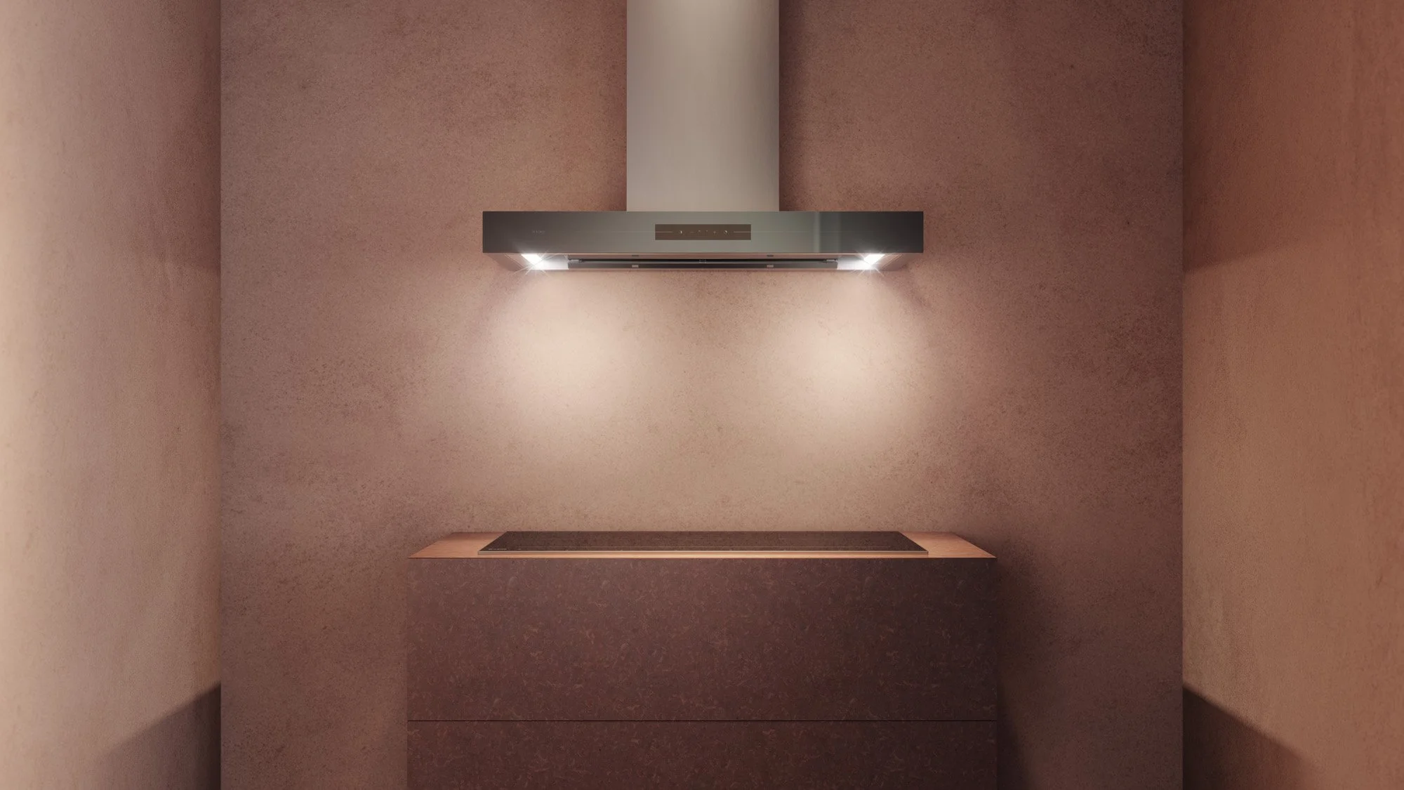 Modern kitchen with pinkish walls, a sleek stainless steel range hood with lights, and a countertop with an induction cooktop.