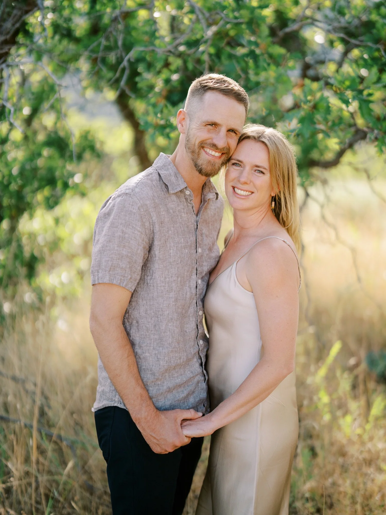 Smiling couple holding hands during their Northern Utah engagement session