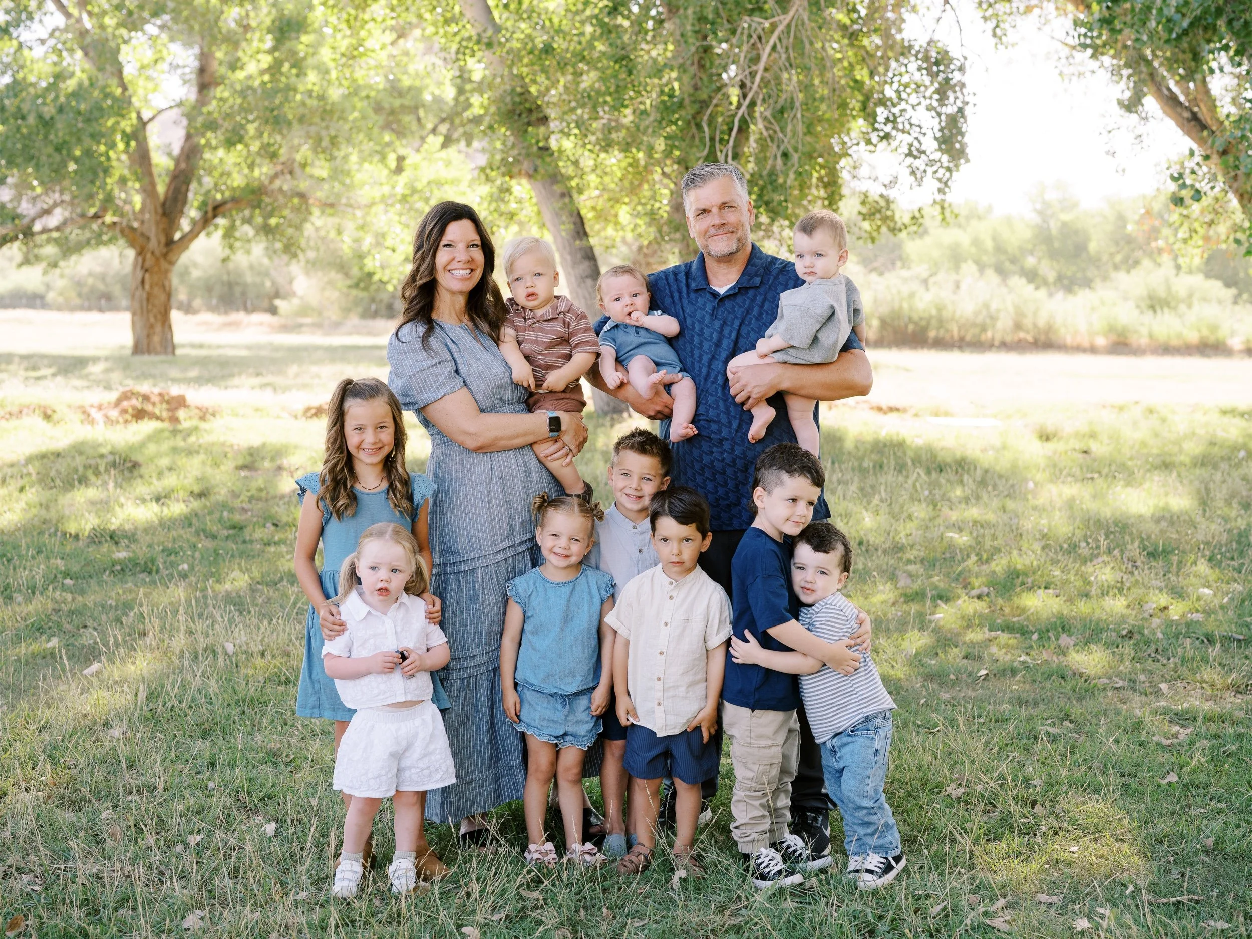 Grandparents with their grandchildren on the grass.
