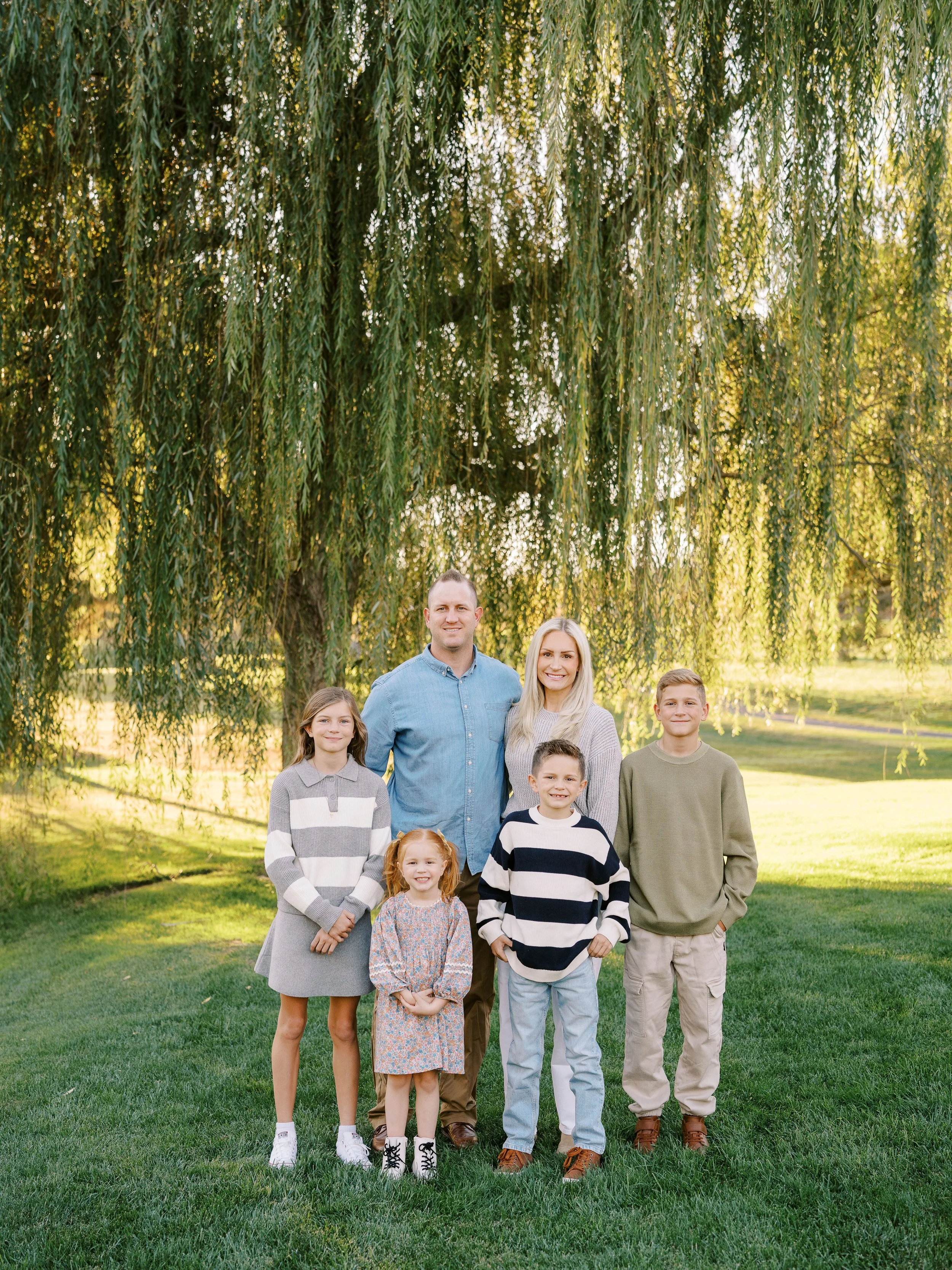Family of six beneath the willow at Red Hills Golf Course