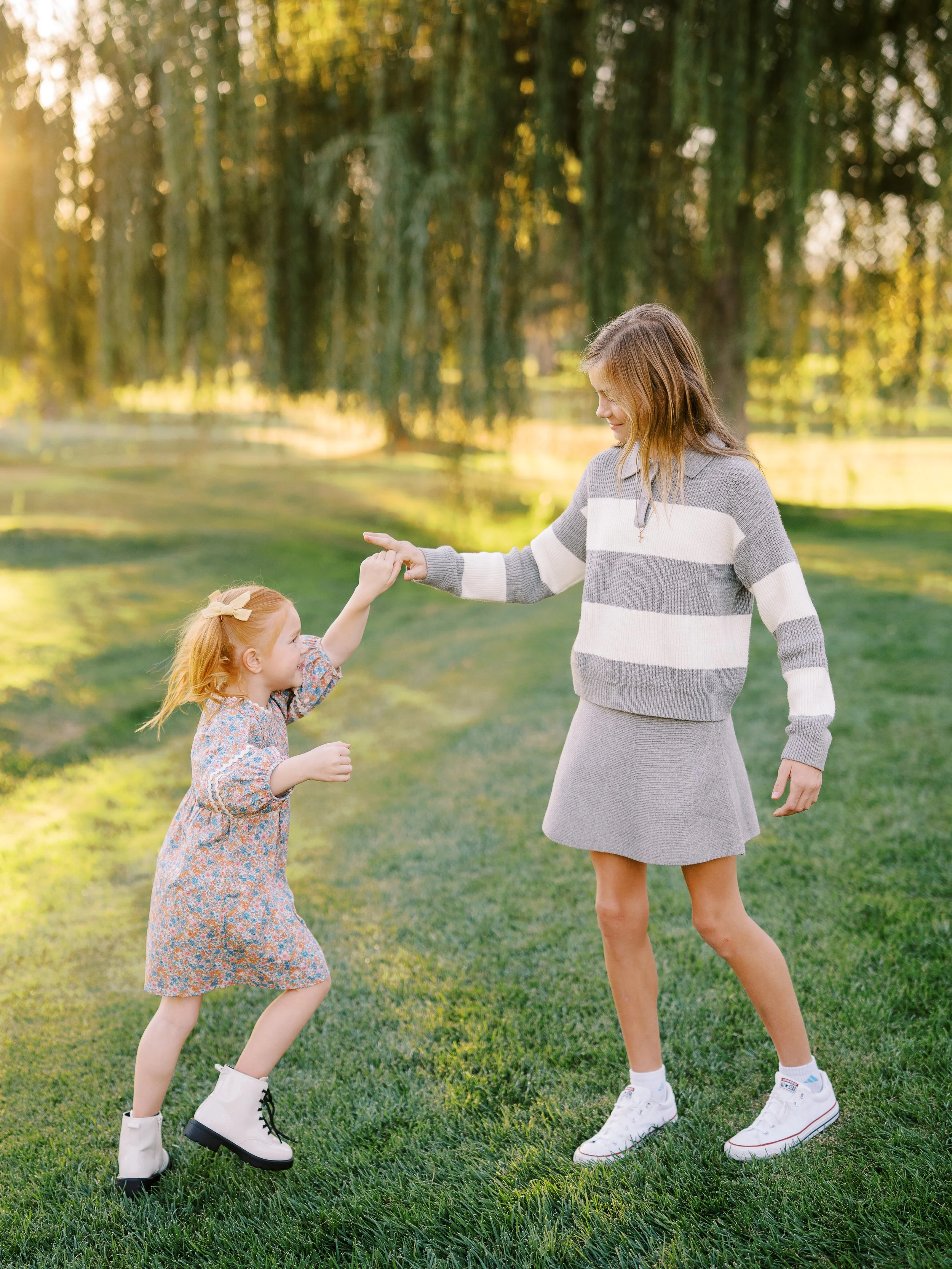 Sisters turning toward one another while holding hands