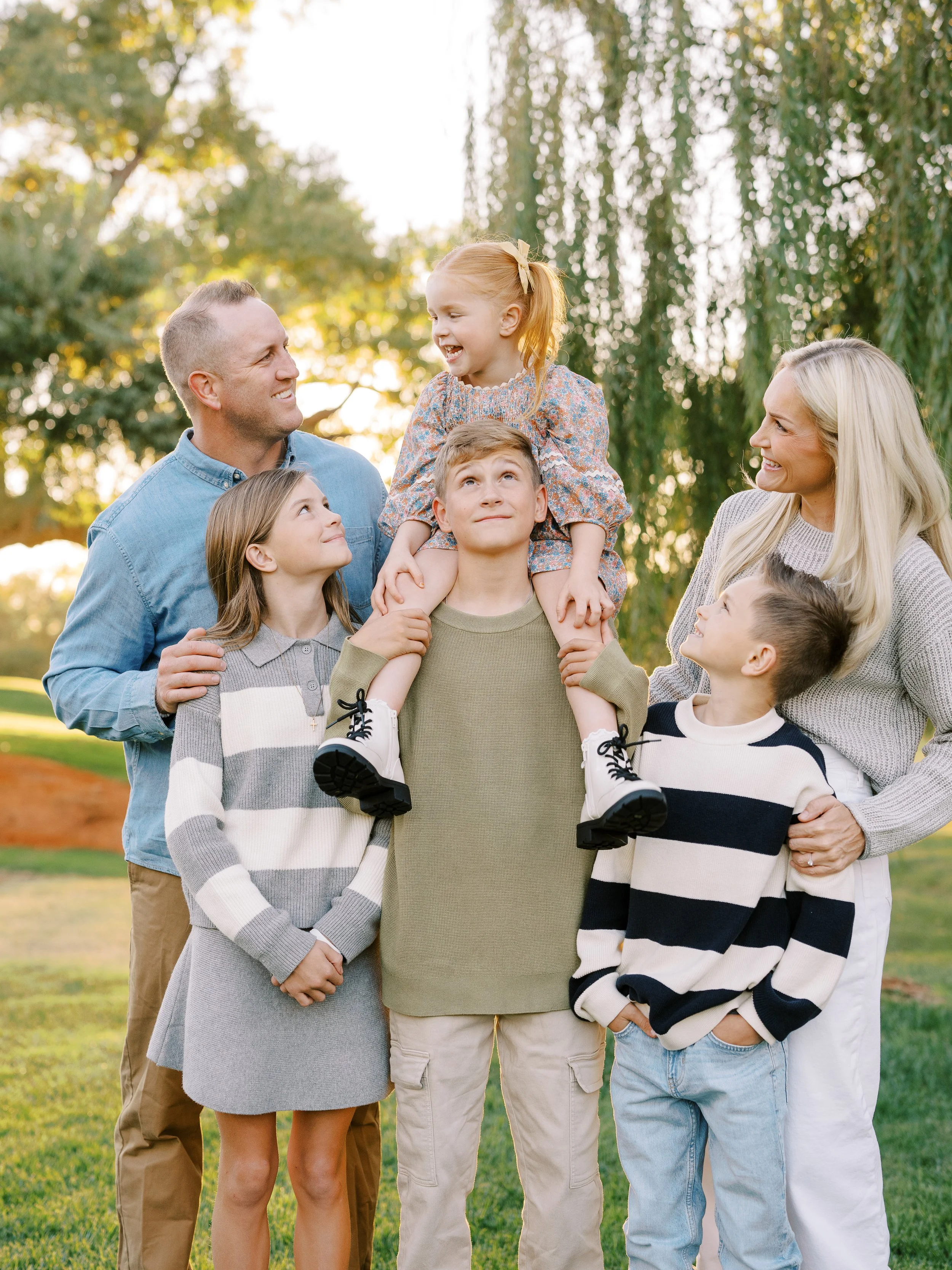 Family laughing and looking at one another during their outdoor session