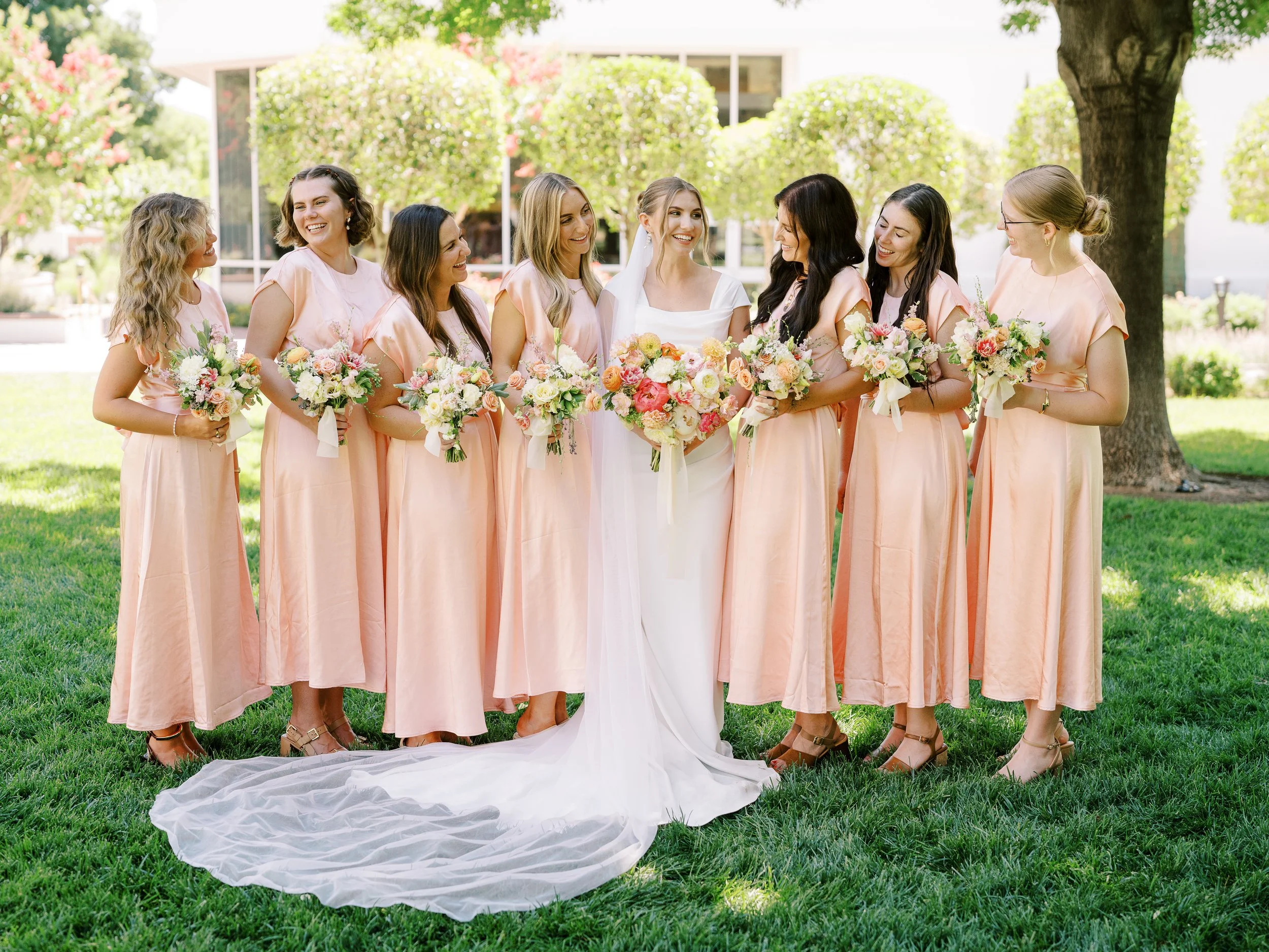 Abby and her bridesmaids smiling at one another