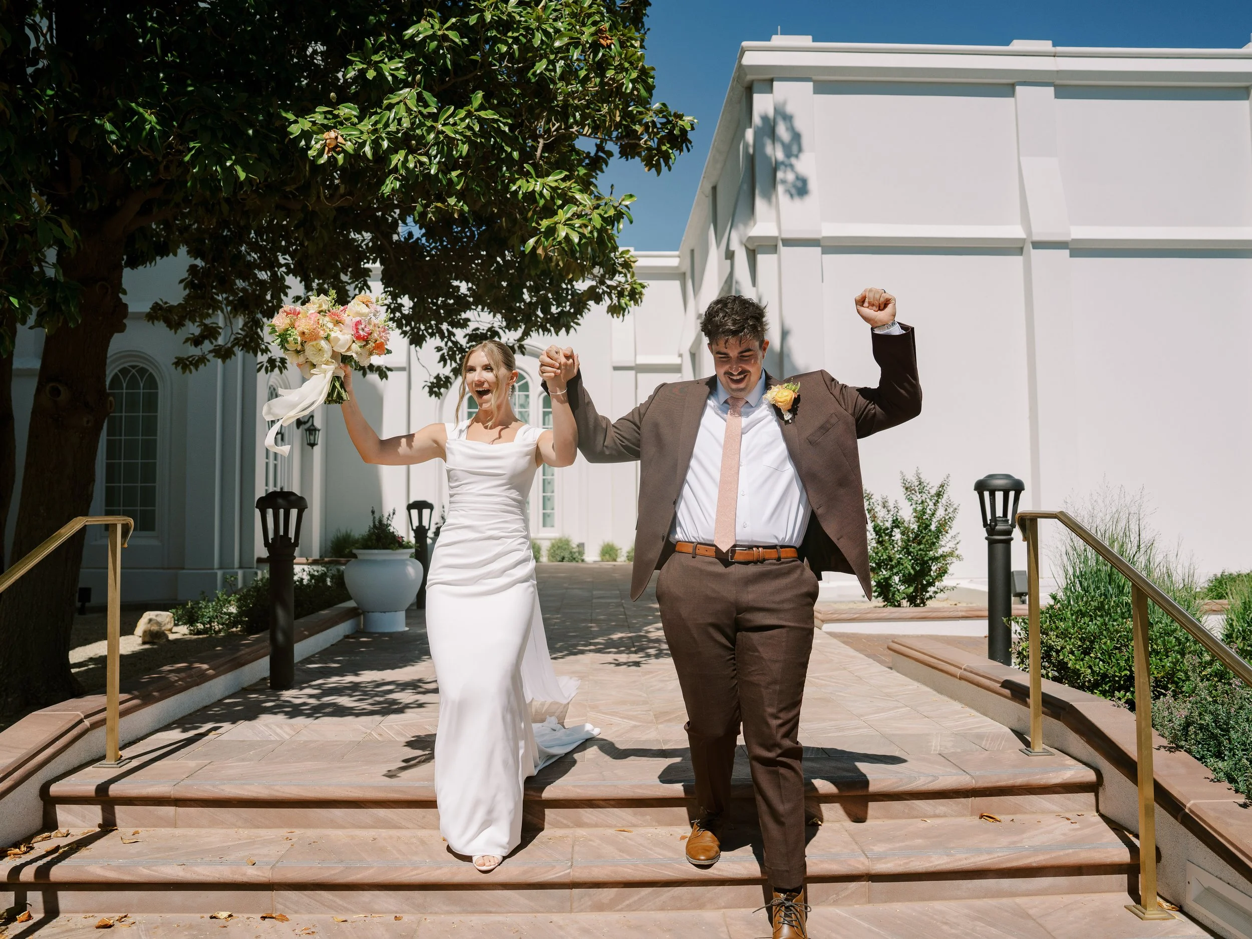 Abby and Noah celebrating on the temple steps