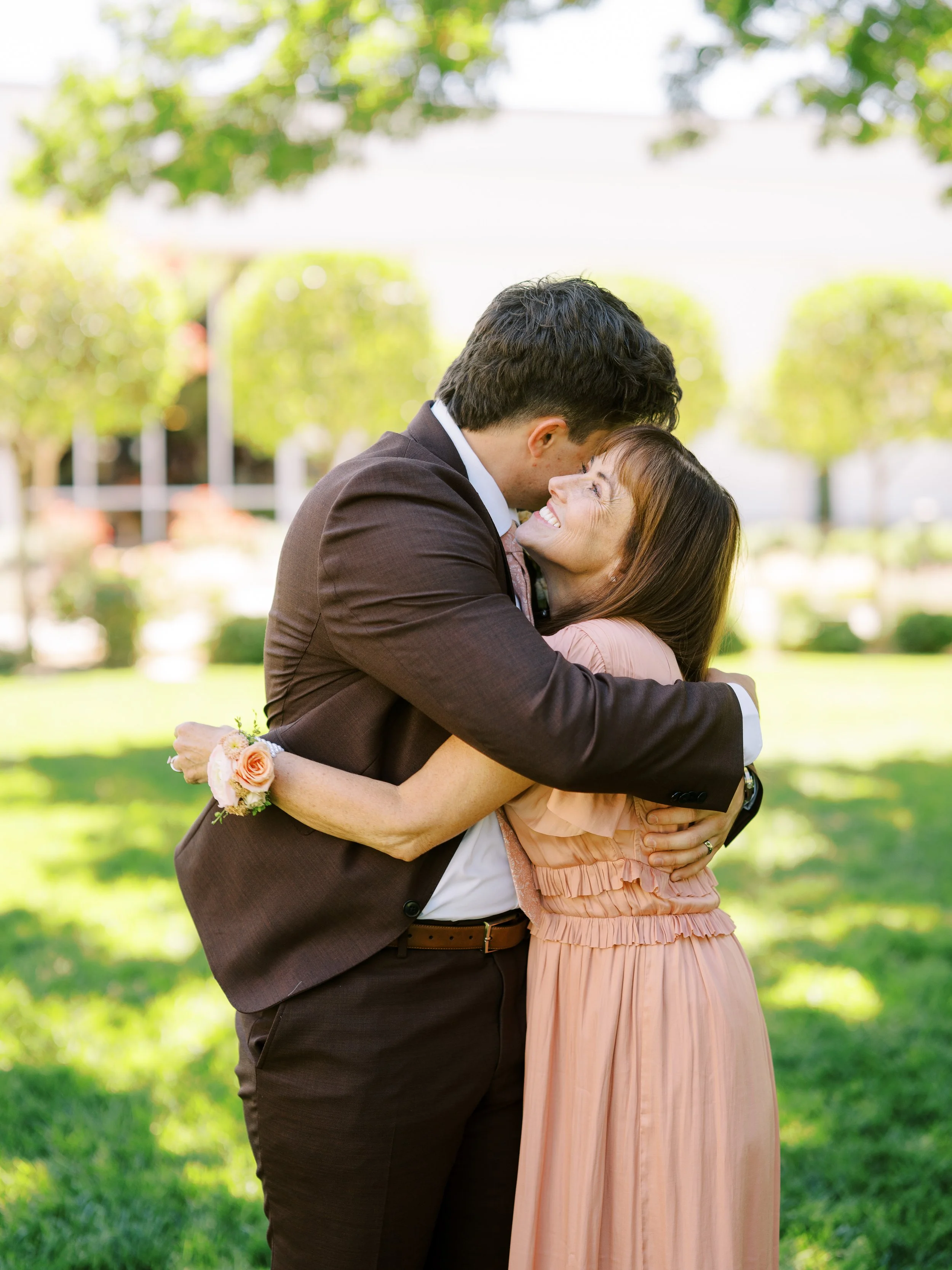 Noah embracing a loved one on the temple lawn