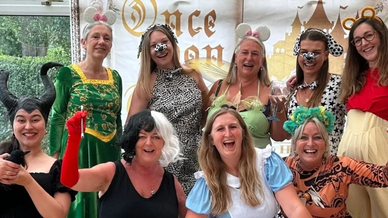 Hen party group posing in costume together after a Disney themed dance class with Dazzle Dance Experience in Mumbles Wales