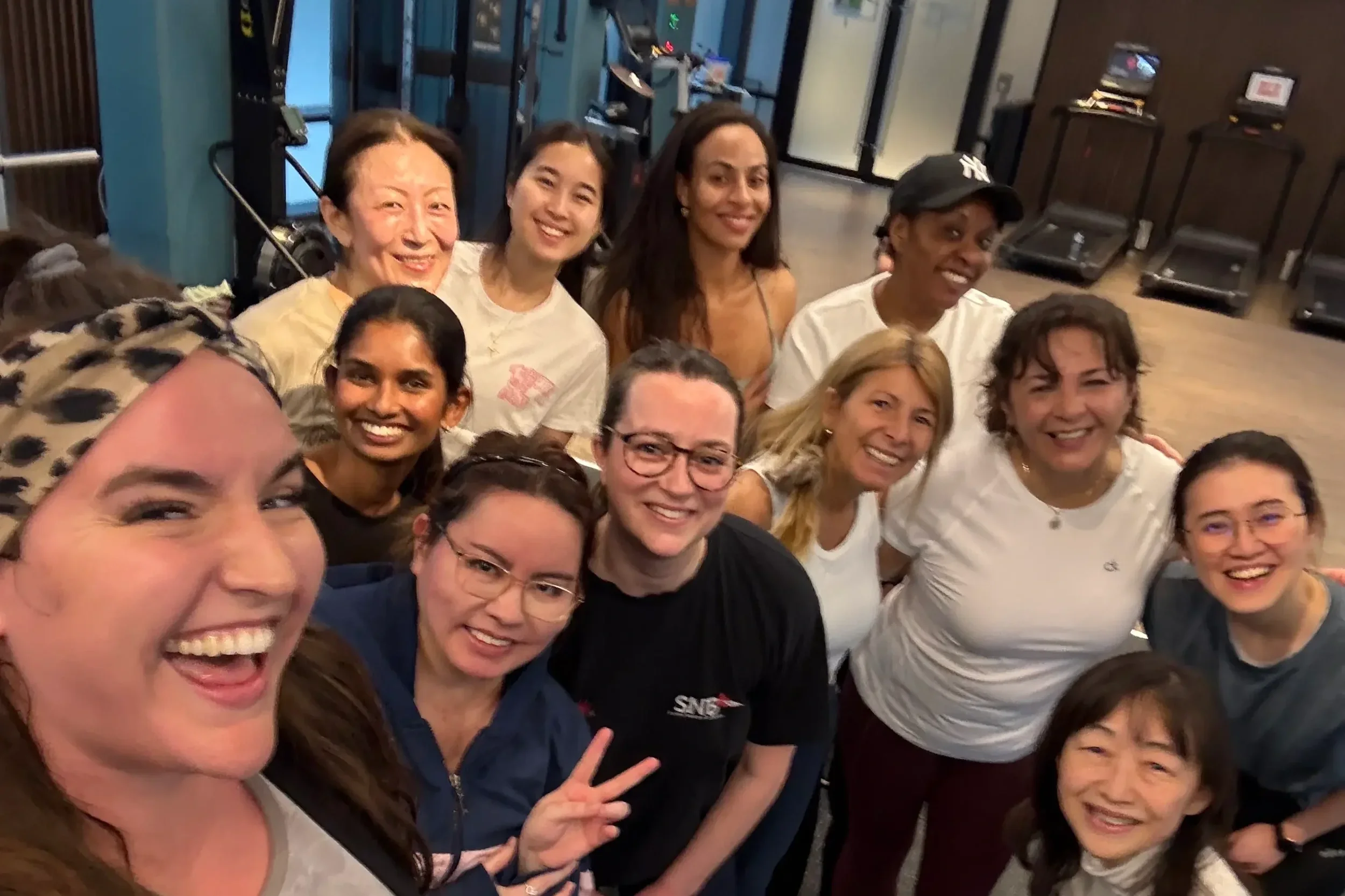 A group of women colleagues posing for a selfie after a corporate dance class