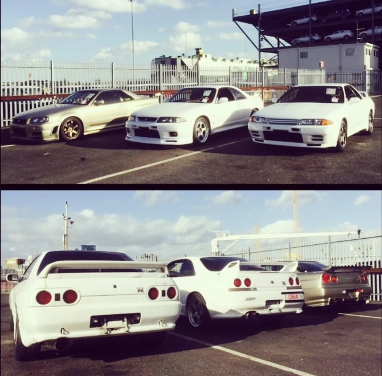 A parking lot with eight Nissan GT-R sports cars, three in the front row and five in the back, all parked side by side, with a fence and shipping containers in the background.
