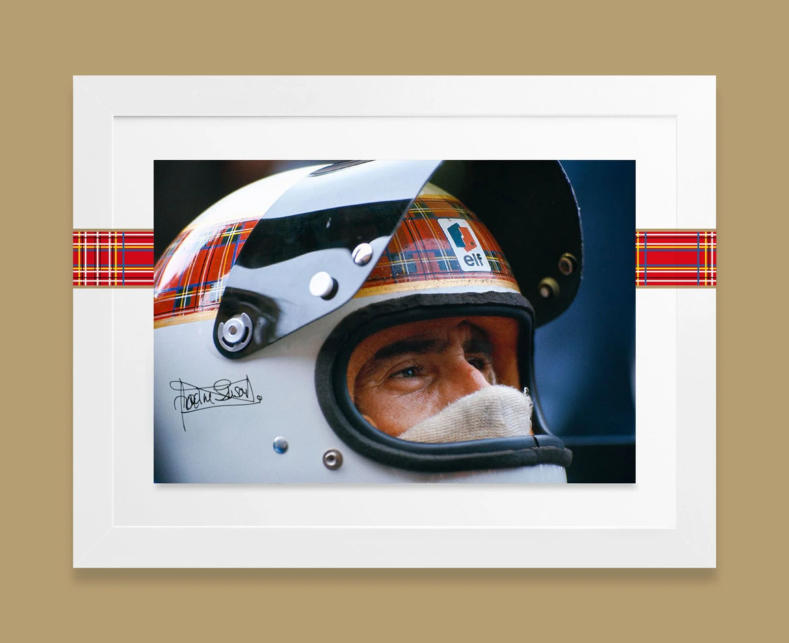 Photograph of a race car driver wearing a white helmet with a tartan pattern and motorcycle goggles, with his eyes visible through the helmet's opening.