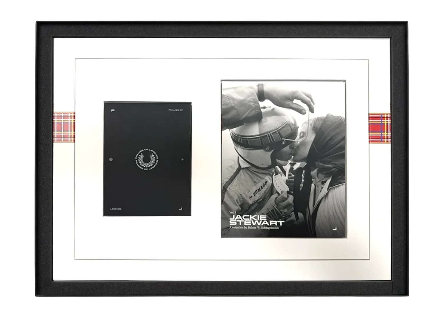 Framed black-and-white photo with a racing helmeted person and another person close in a kiss, with a poster reading Jackie Stewart and a black rectangular object on a white background.