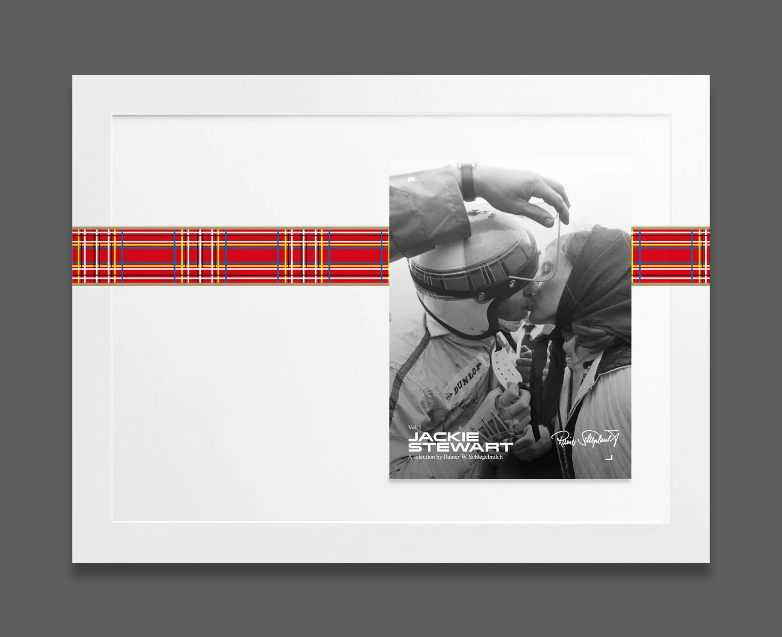 A framed black and white photograph of two race car drivers sharing a kiss, with the name Jackie Stewart and a selection by Rainer W. Schlegelmilch on the cover.