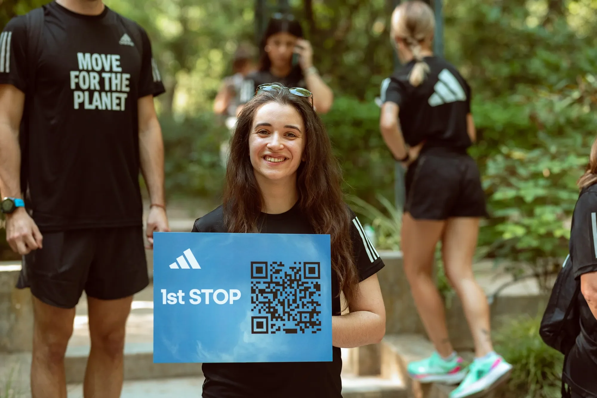 A girl hold 1st stop banner during Move For The Planet  scavenger hunt  in London