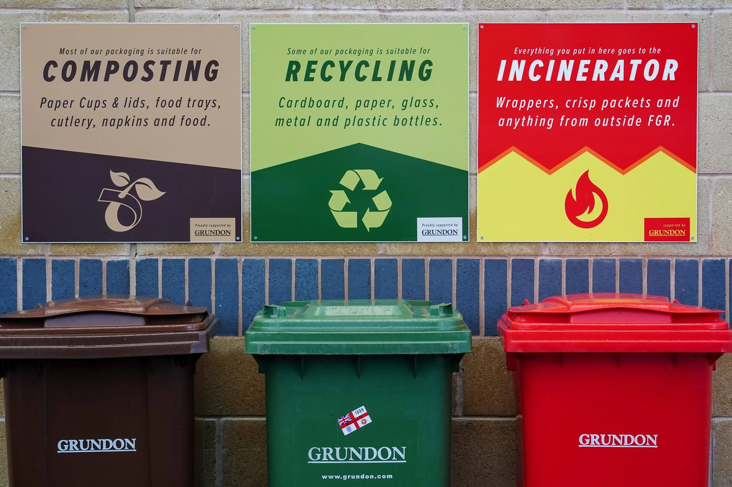 Recycling station with three bins at Forest Green Rovers stadium for collecting compostable plastic cups provided through the BioPack partnership.