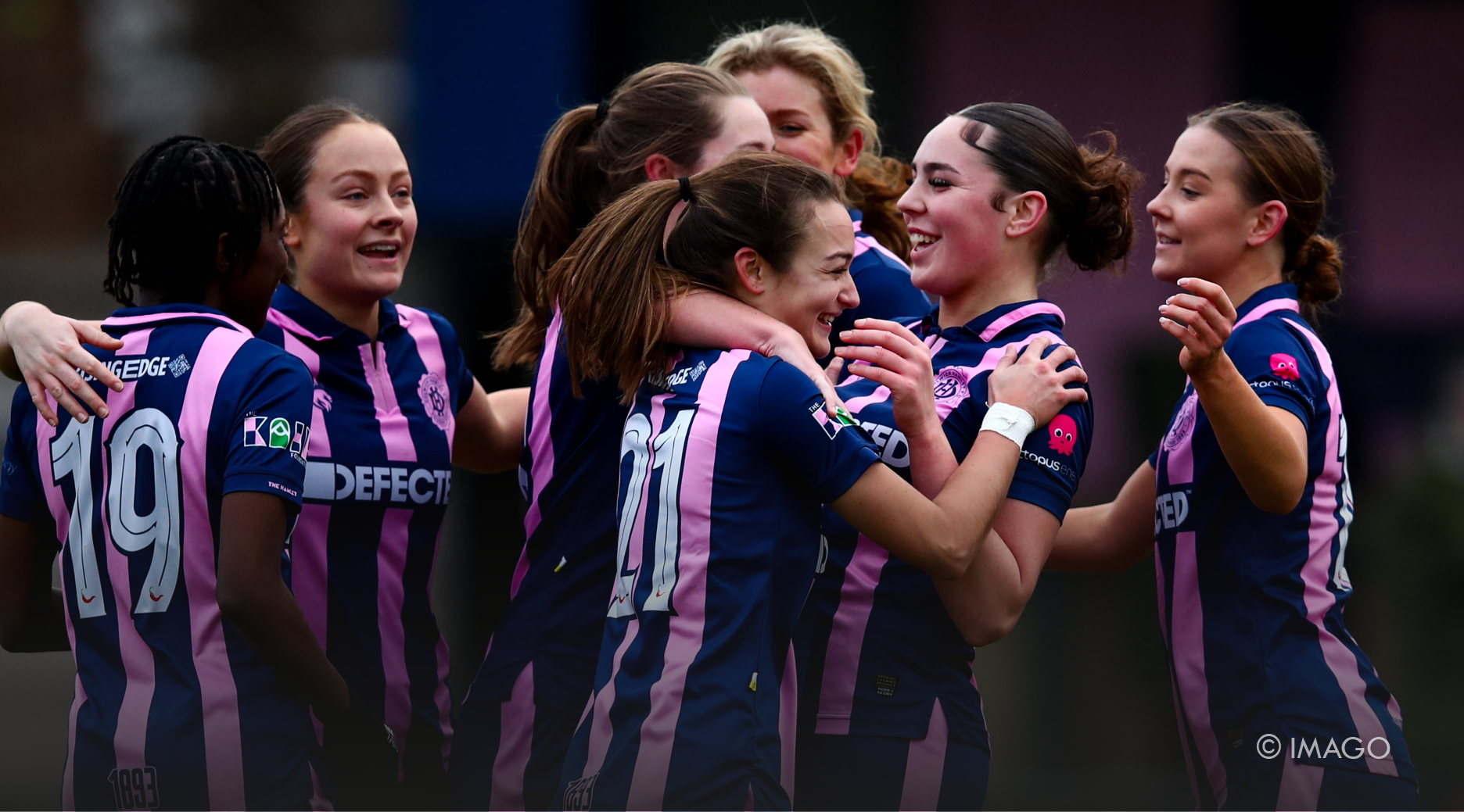 UK football female team hugging after a win