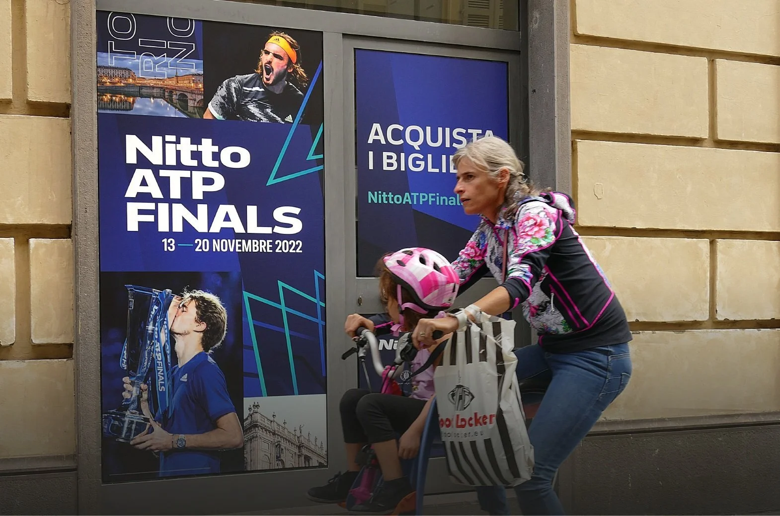 Mum and daughter looking at the poster of Nitto ATP Finals