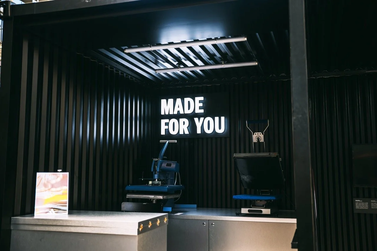 Close-up of a customization station at the Paris 2024 adidas Rising Phoenix activation