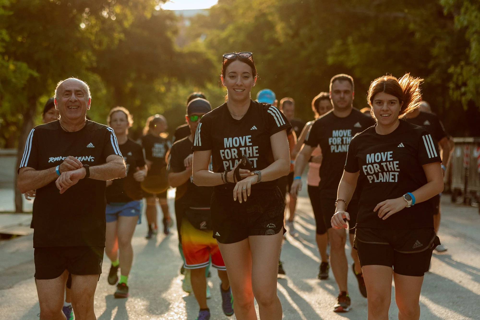 Group of people running and joining hands for the adidas 2022 Run for the Oceans campaign