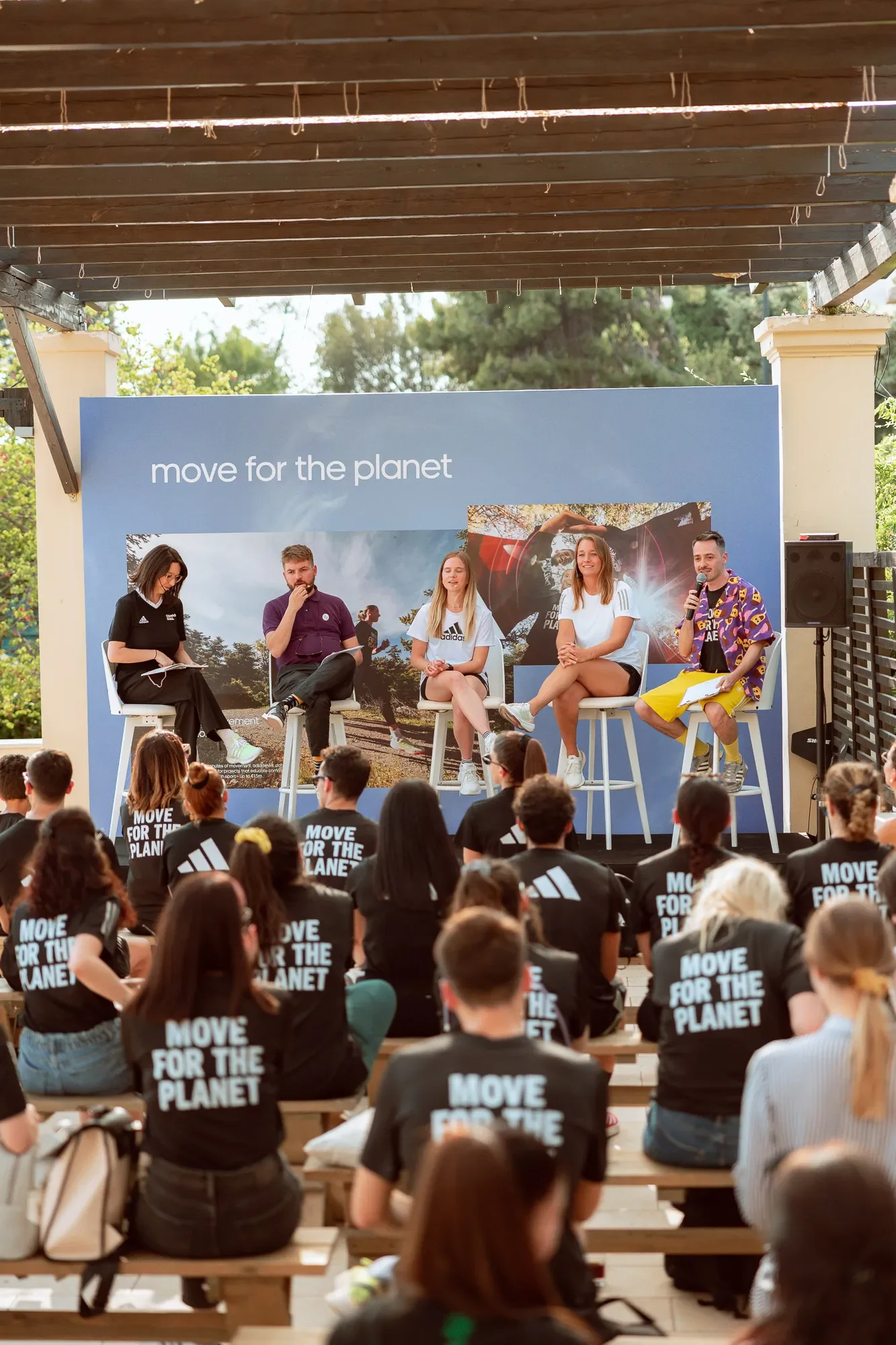 Five people taking a panel in front of Move For The Planet participants