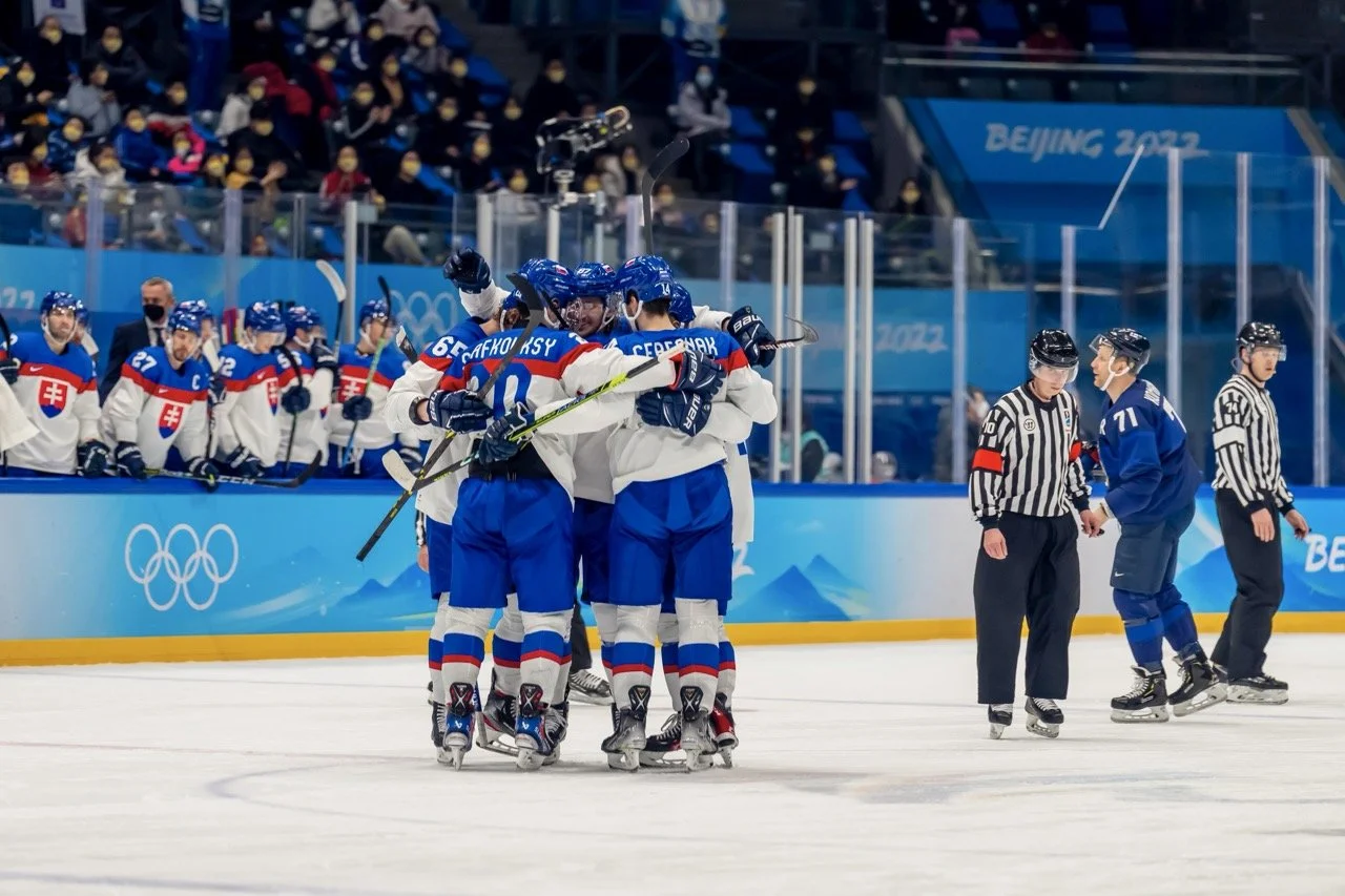 A group of Team Slovakia hockey players huddle on the ice at the Paris 2024 Olympics