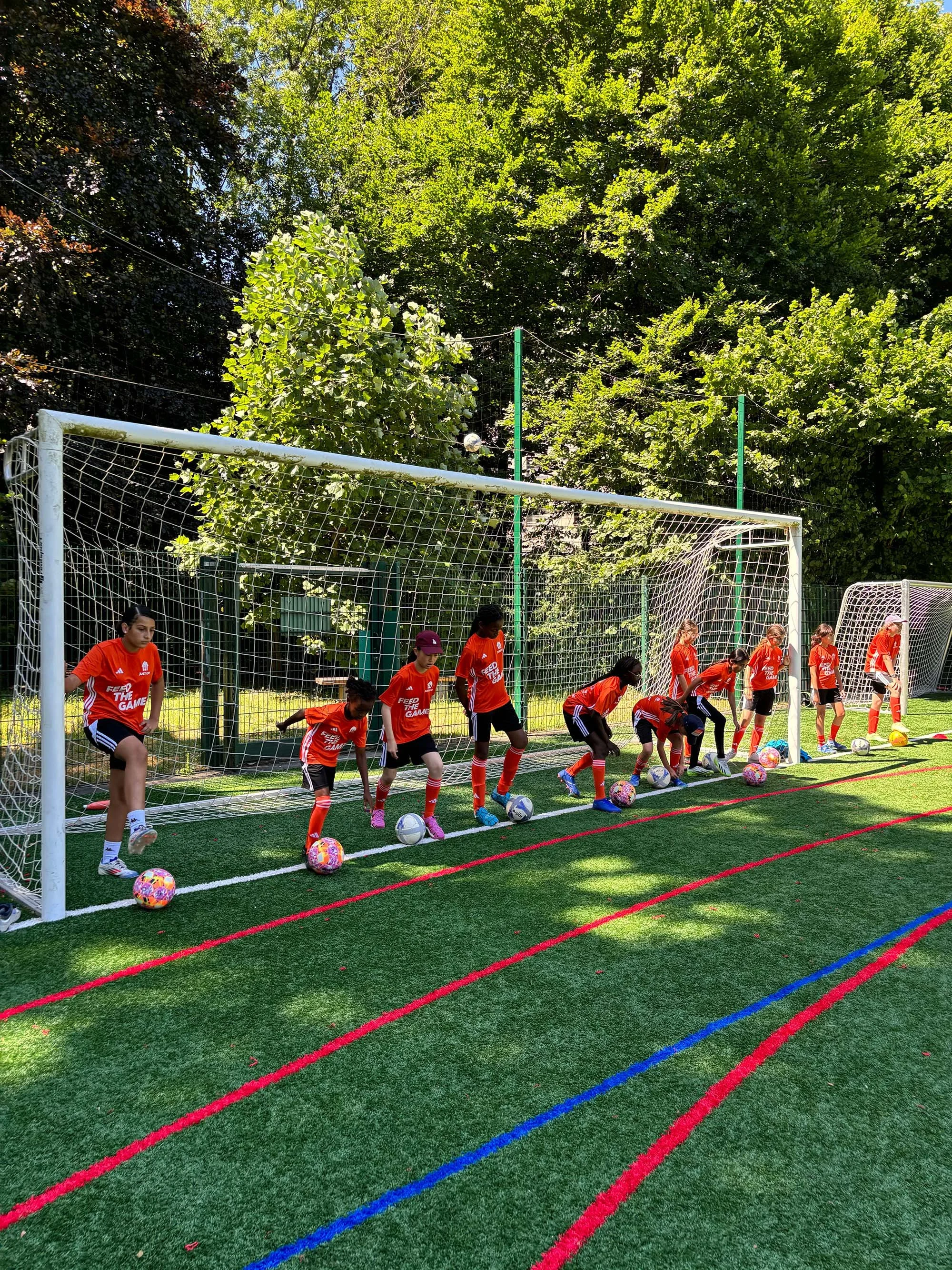 Young players training football at Feed The Game camp