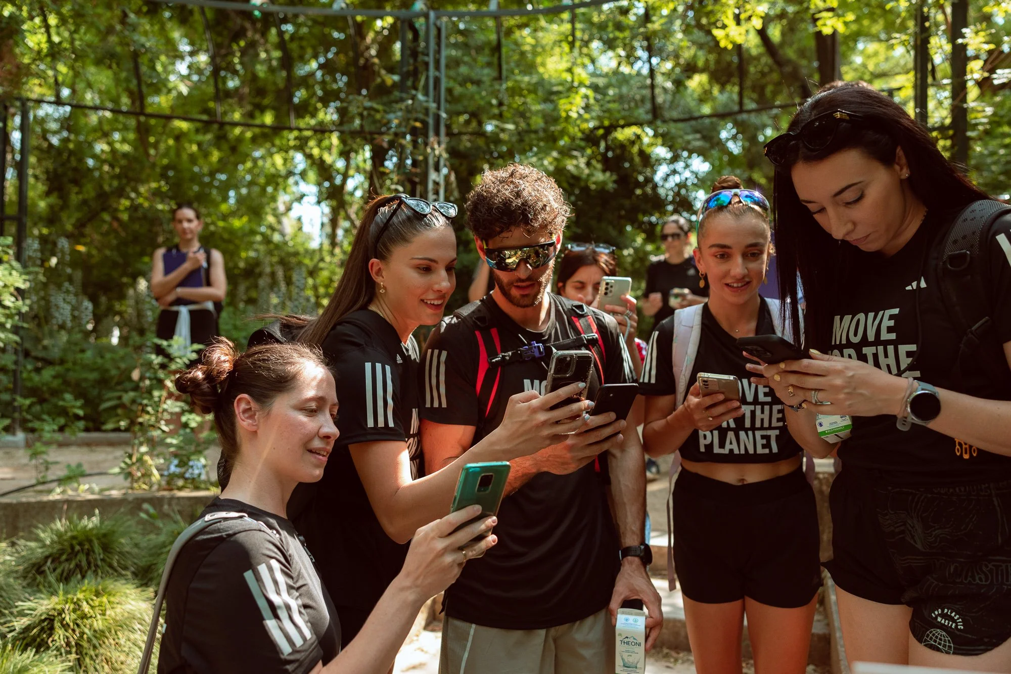 Group of people looking at their phones during Move For The Planet scavenger hunt in London