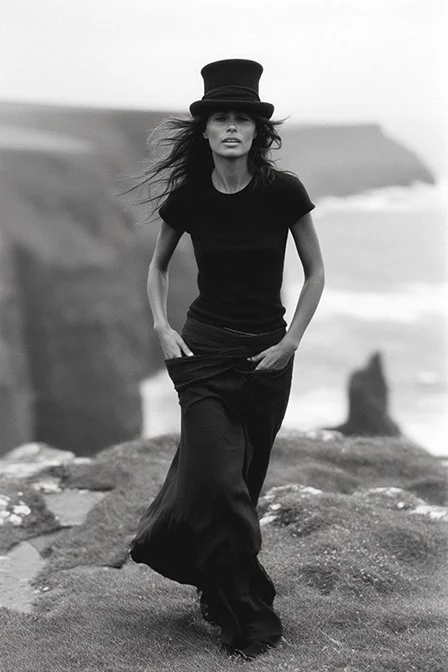 A woman standing on a rocky beach with cliffs and ocean in the background, wearing a black top hat and black clothing. Ai Generated, Creative direction with  AI 