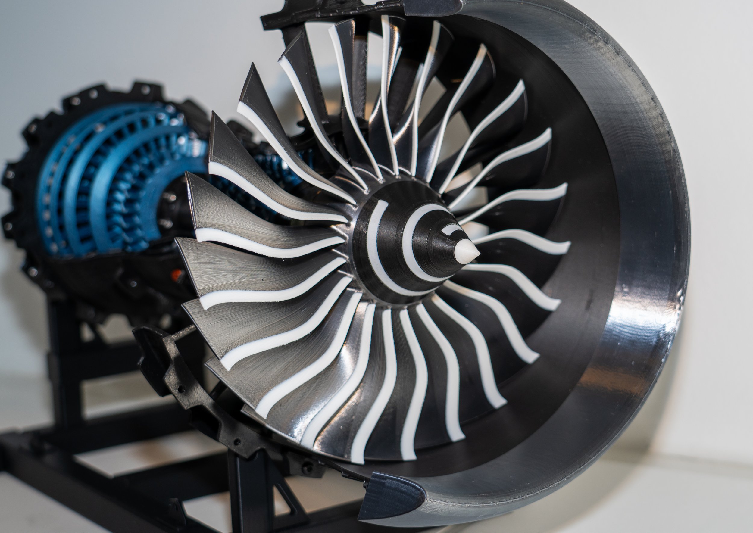 A detailed computer-generated image of a jet engine turbine, showing the spinning blades and intricate internal components.