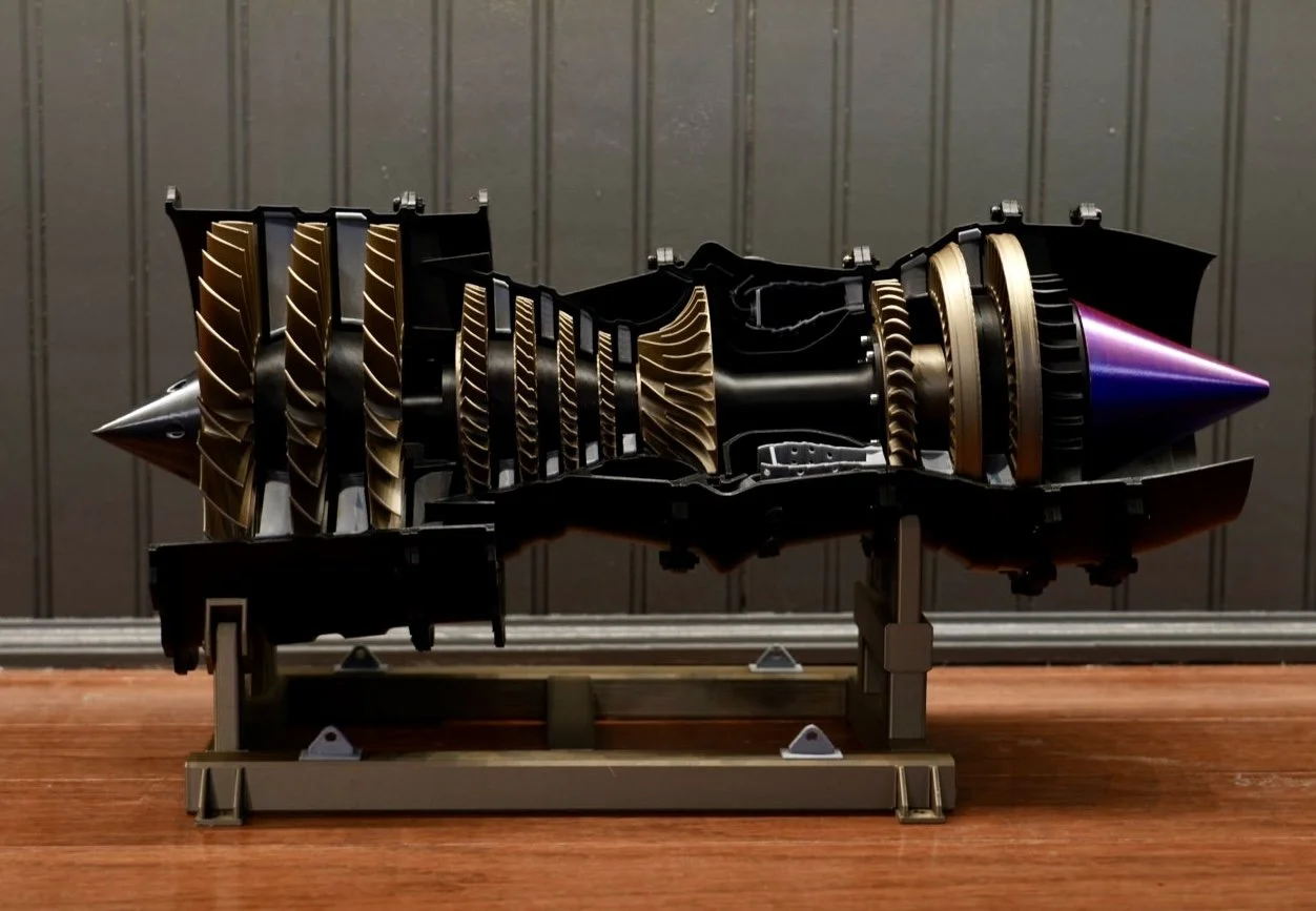 Cutaway view of a jet engine showing turbine blades and internal components.