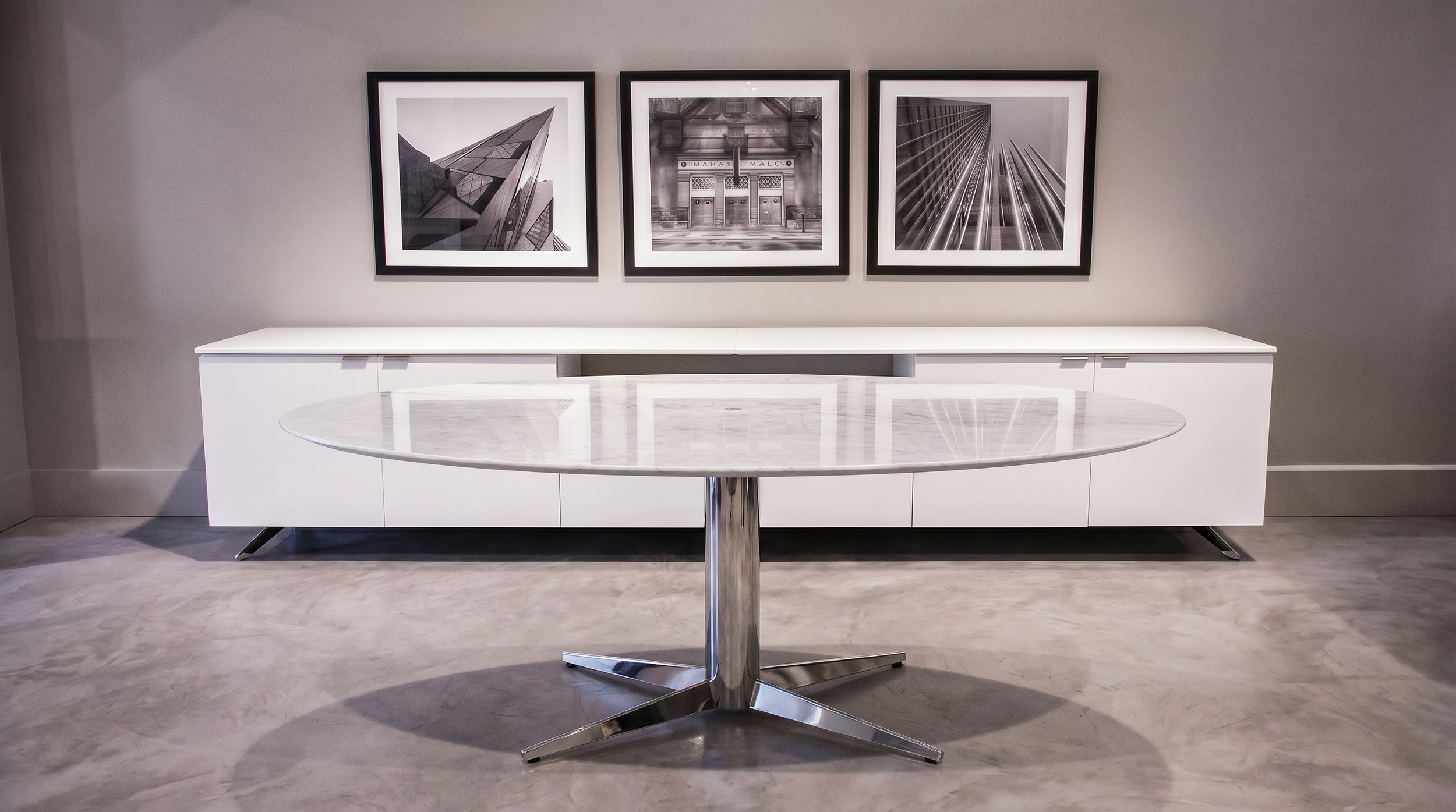 Asteri collaborative meeting table with natural stone tabletop and chrome base.