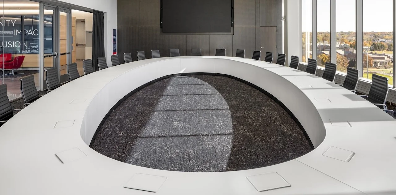 Large oval O conference room table with white tabletop and side modesty