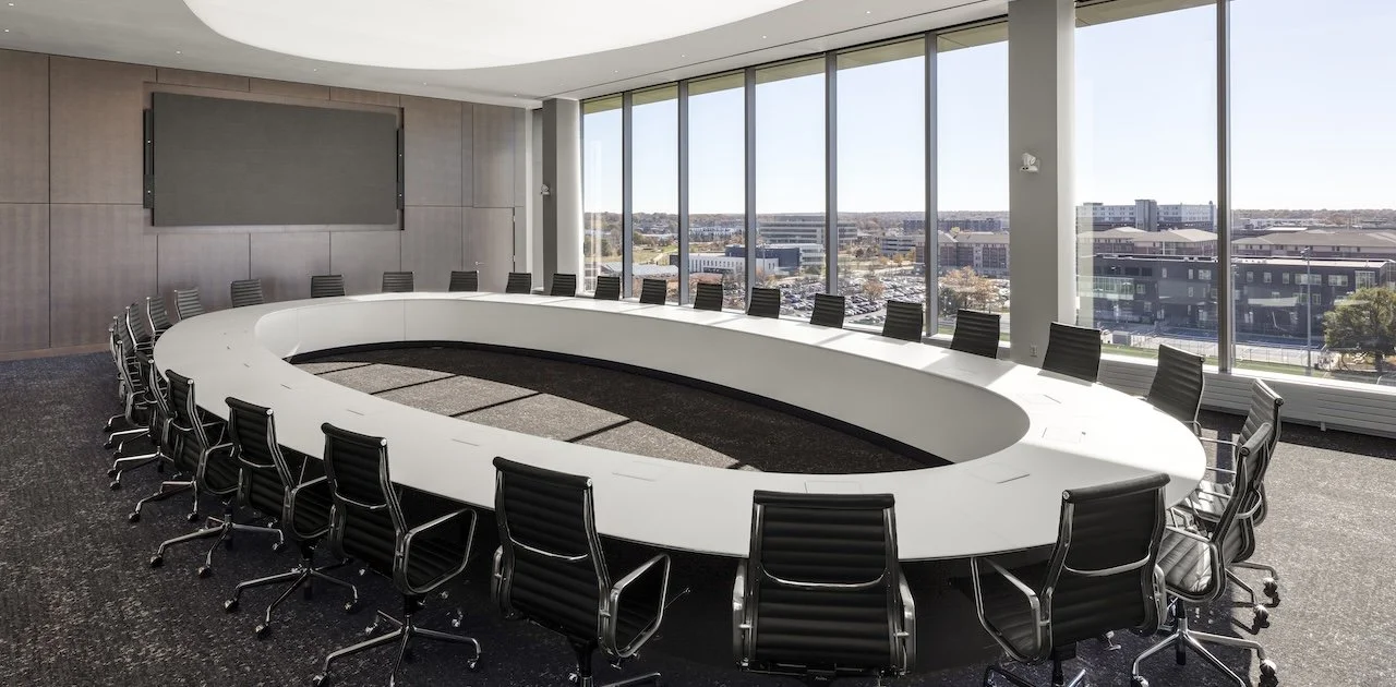 Large oval O conference room table with white tabletop and side modesty