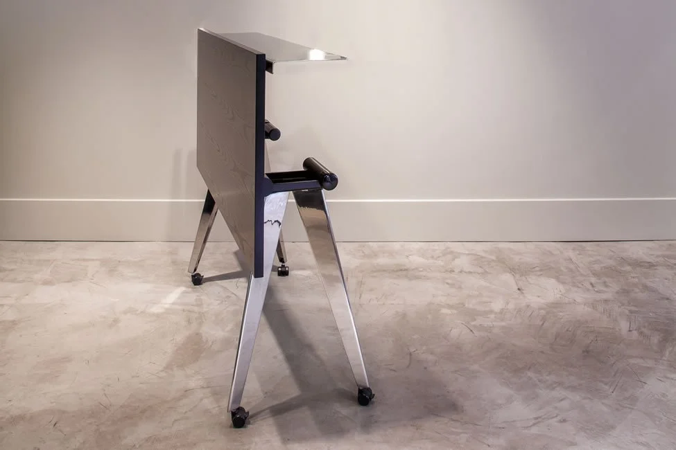 Side view of a Flatiron training table showing how the tabletop can be maneuvered into a vertical position.