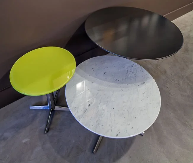 Three Asteri collaborative and cafe tables in various round dimensions, colours, and heights.