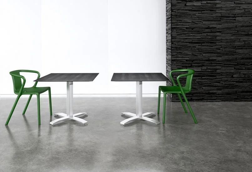 Two Nextt Cross Base square community tables with wood veneer tabletops and chrome bases.