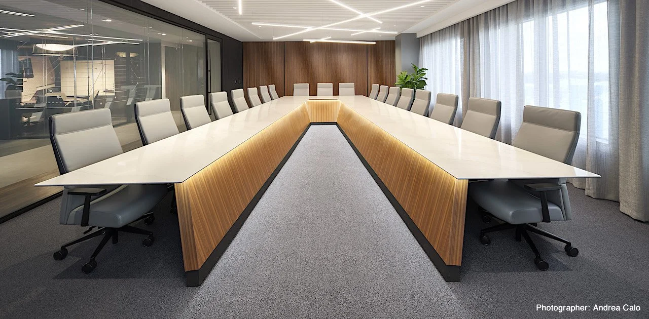 Long V-Shaped conference room table.