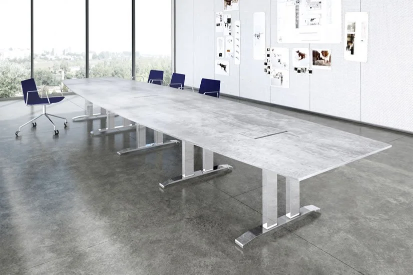 Empty modern conference room with large gray table, blue chairs, and a wall with artwork