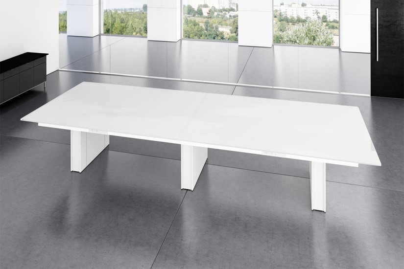 White tabletop conference table with triple white Panel bases in a bright office with large windows and city view.