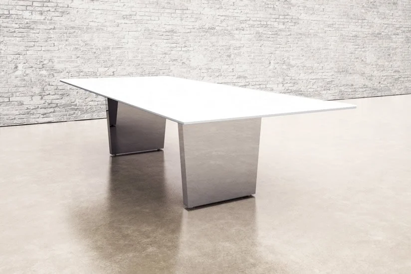 Modern rectangular white table with metallic base in a minimalist room with a white brick wall