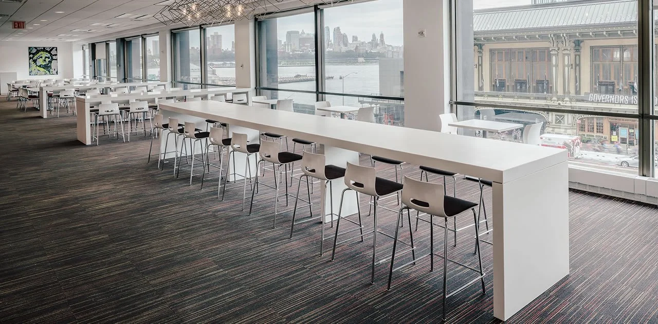 High community tables with white tabletop and matching white base.