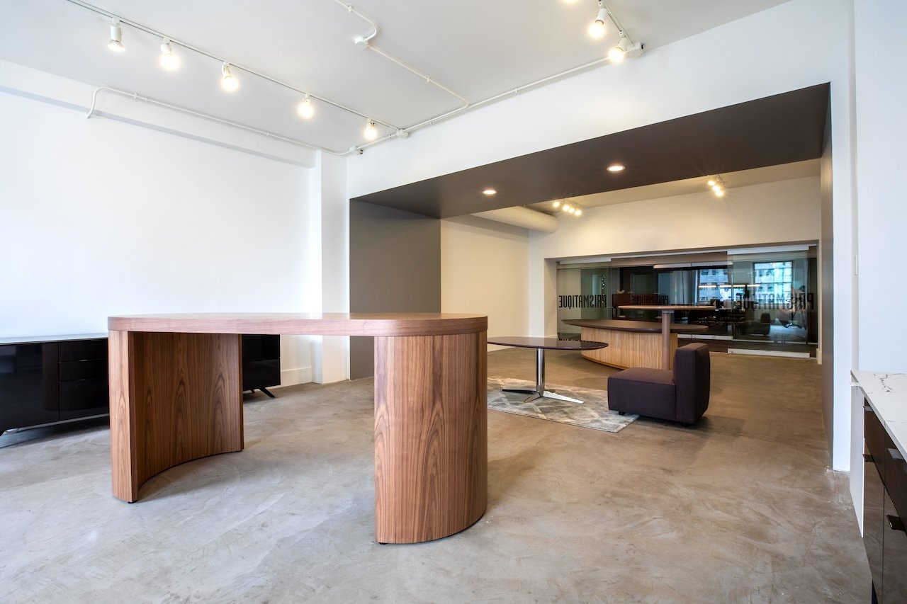Crescent community table in wood veneer.