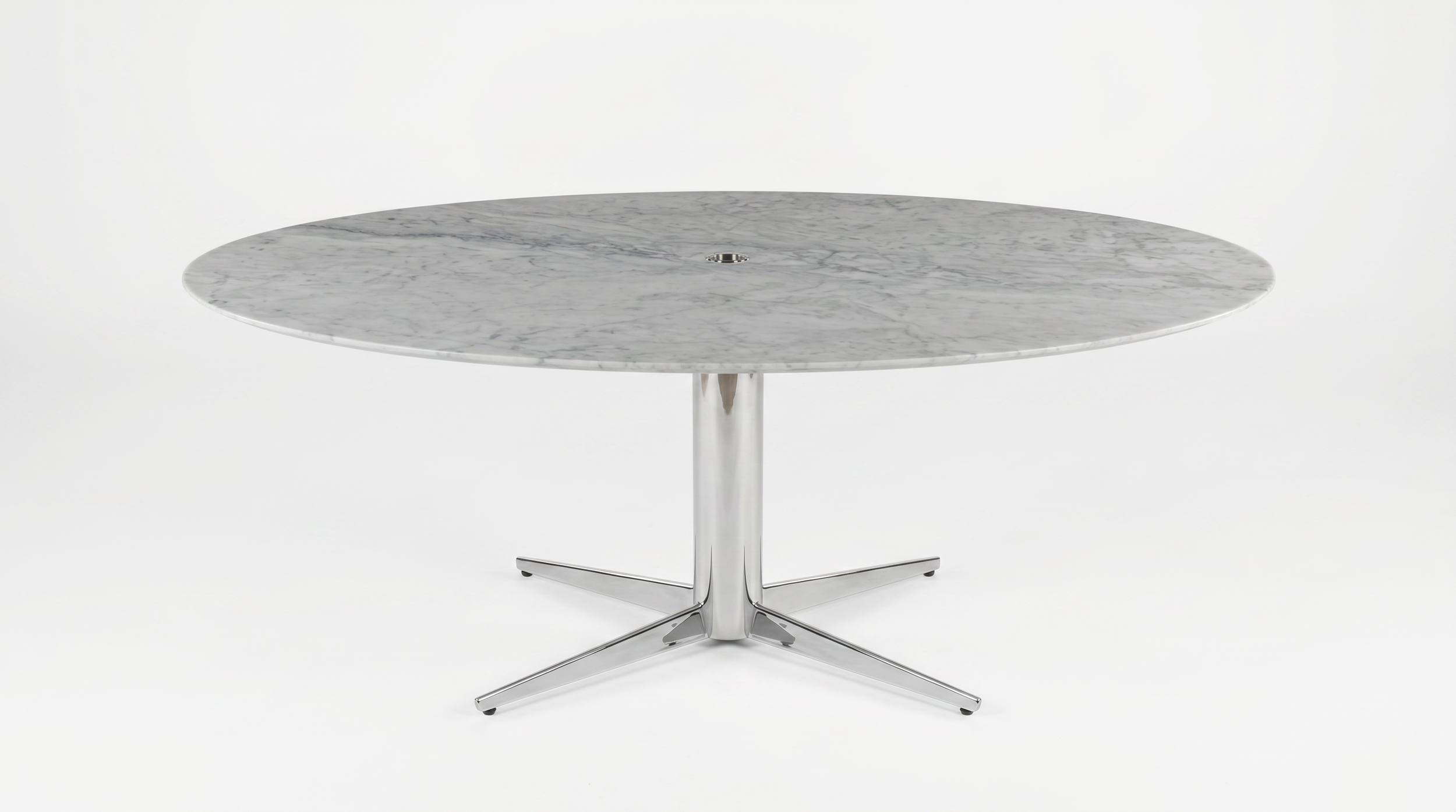 Asteri collaborative table with natural stone tabletop and chrome base.
