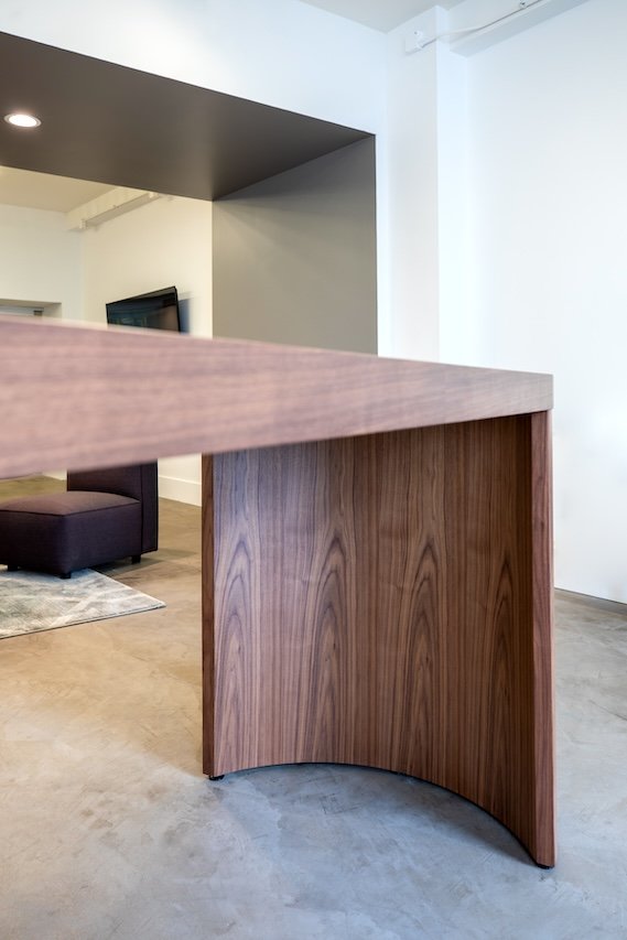 Crescent community table in wood veneer.